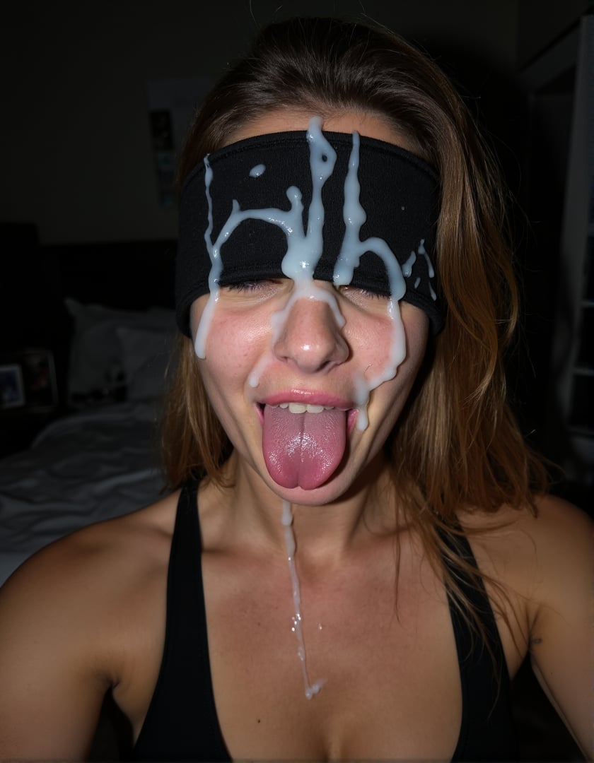 low light selfie of a women in a bedroom wearing a blindfold. She has a massive amount of cum on her face. long cum ropes, thick cum, vertical ropes, hair cum, cum over eye, sticking tongue out