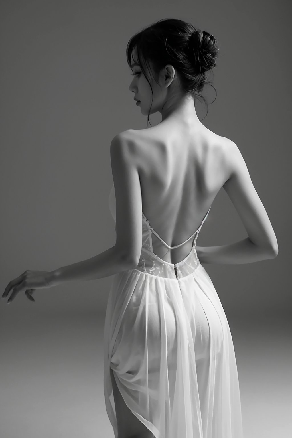 solo,1girl,monochrome,greyscale,is dancing,ballet,dance,updo,bare shoulders,backless outfit,dress,skirt,wind,braid,single hair bun,backless dress,<lora:heibai_20231113120702:0.5>,