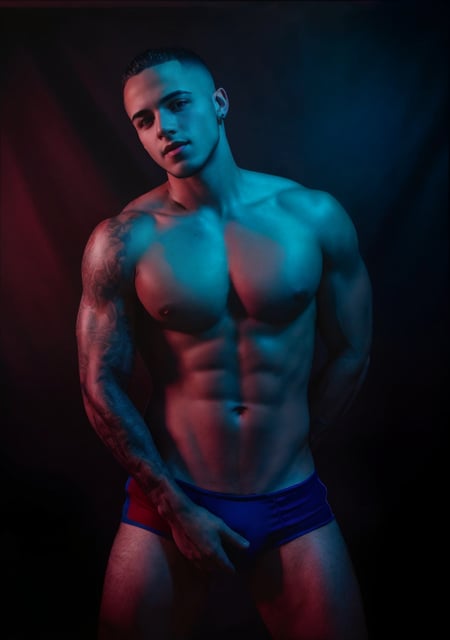 <lora:Jordan_Torres-v1:0.5> jordan_torres <lora:Studio_lighting:.7> Studio lighting, low saturation, (red and blue lighting), grey background, realistic Photo of a young man, bulge, muscular, dark, close up portrait, high detail, realistic, high detail, 8k, (Masterpiece, high quality:1.3), masterpiece, depth of field, bokeh, detailed, homoerotic, (homoerotic), highly detailed, sharp focus, intricate, smooth, elegant, fantasy, masterpiece, matte, photorealistic, 4k, beautiful,