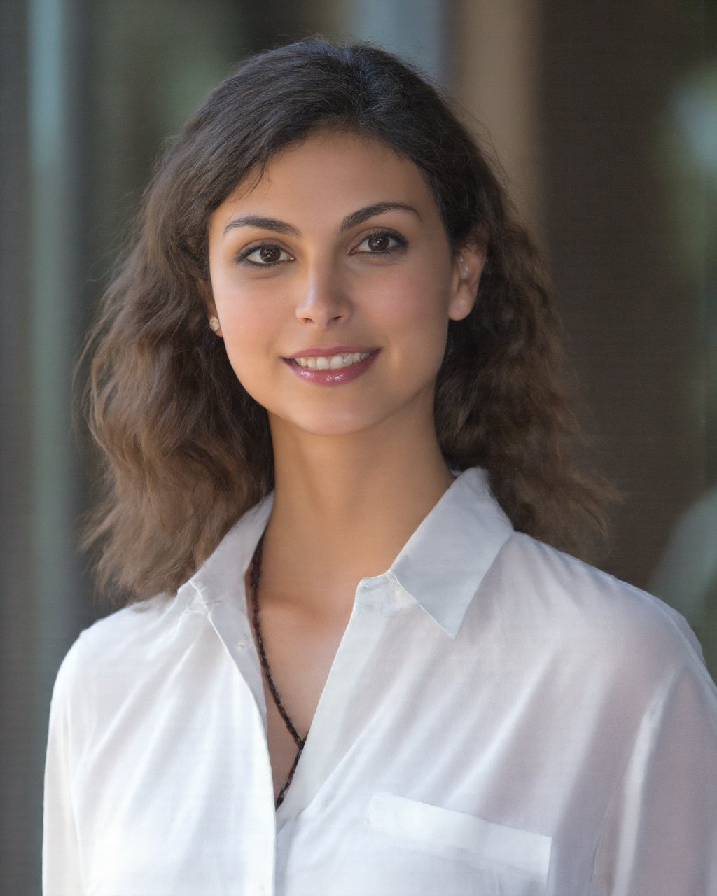 morena_baccarin, A woman is standing in front of a window. She is wearing a white shirt that is draped over her shoulders. The woman has shoulder length brown hair. 