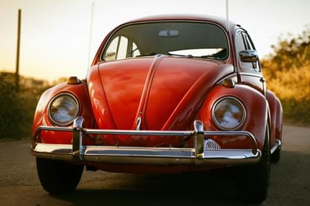 analog gloomy photo of a (red) Volkswagen Beetle car, <lora:vwb33tl3:1>, dark sunset, decayed and dilapidated buildings, 1969, ((horror movie)), slasher film, texas chainsaw massacre, film grain, retro,  High Detail, Sharp focus, ((photorealism)), realistic, best quality, 8k, award winning, dramatic lighting, epic, cinematic, masterpiece 