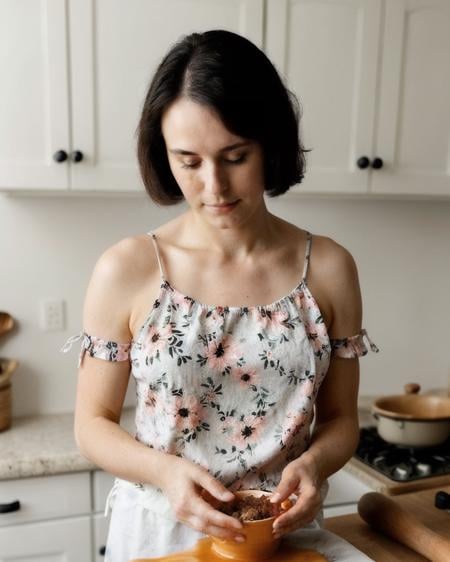 instagram photo of woman wearing a cute flowery top, cooking, looking down  <lora:all_eyes_hands_skin_fin:0.5>