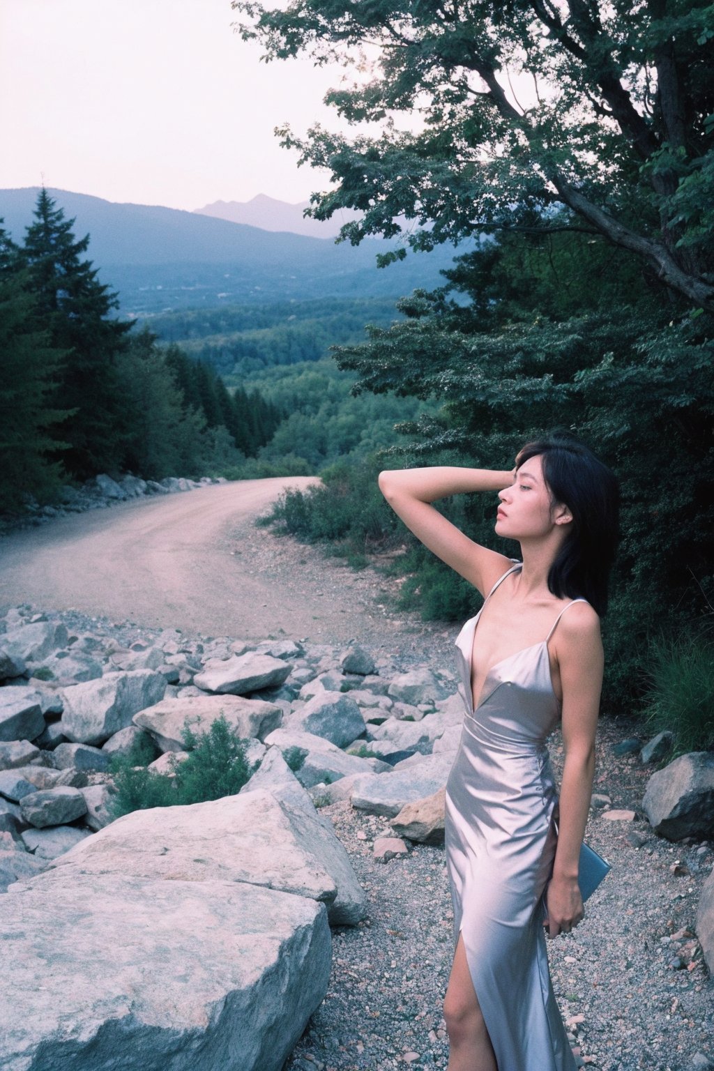  A girl, her hair flowing in the wind, stands on a rocky outcrop in the forest, the trees stretching out behind her. The scene is captured using a Fujifilm X-T3 with a 16-55mm f/2.8 lens, the image having a sharp and clear focus. The photograph has a sense of drama and tension, inspired by the works of Helmut Newton.