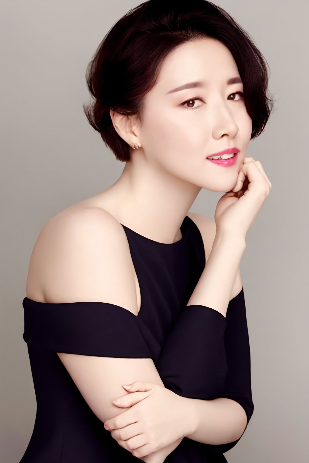 1girl,solo,looking at viewer,short hair,simple background,black hair,dress,bare shoulders,brown eyes,upper body,parted lips,teeth,hand up,grey background,black eyes,lips,realistic