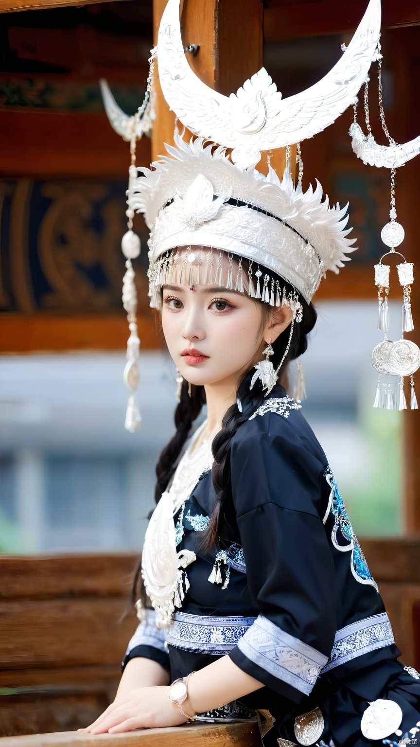 1girl, Leaning sideways, the upper half of the body leaning forward, above the buttocks, holding the hem of the skirt with both hands, looking at the camera, blurred background, braided double ponytail, depth of field, earrings, hat, Miao Silver Phoenix Crown, Miao costume, Black Miao costume, crescent headdress, complex jewelry, super complex metal headdress, silver metal headdress, jewelry, lips, long hair, watch audience, motion blur, necklace, street, architecture, photo (center) , photo reality, solo,