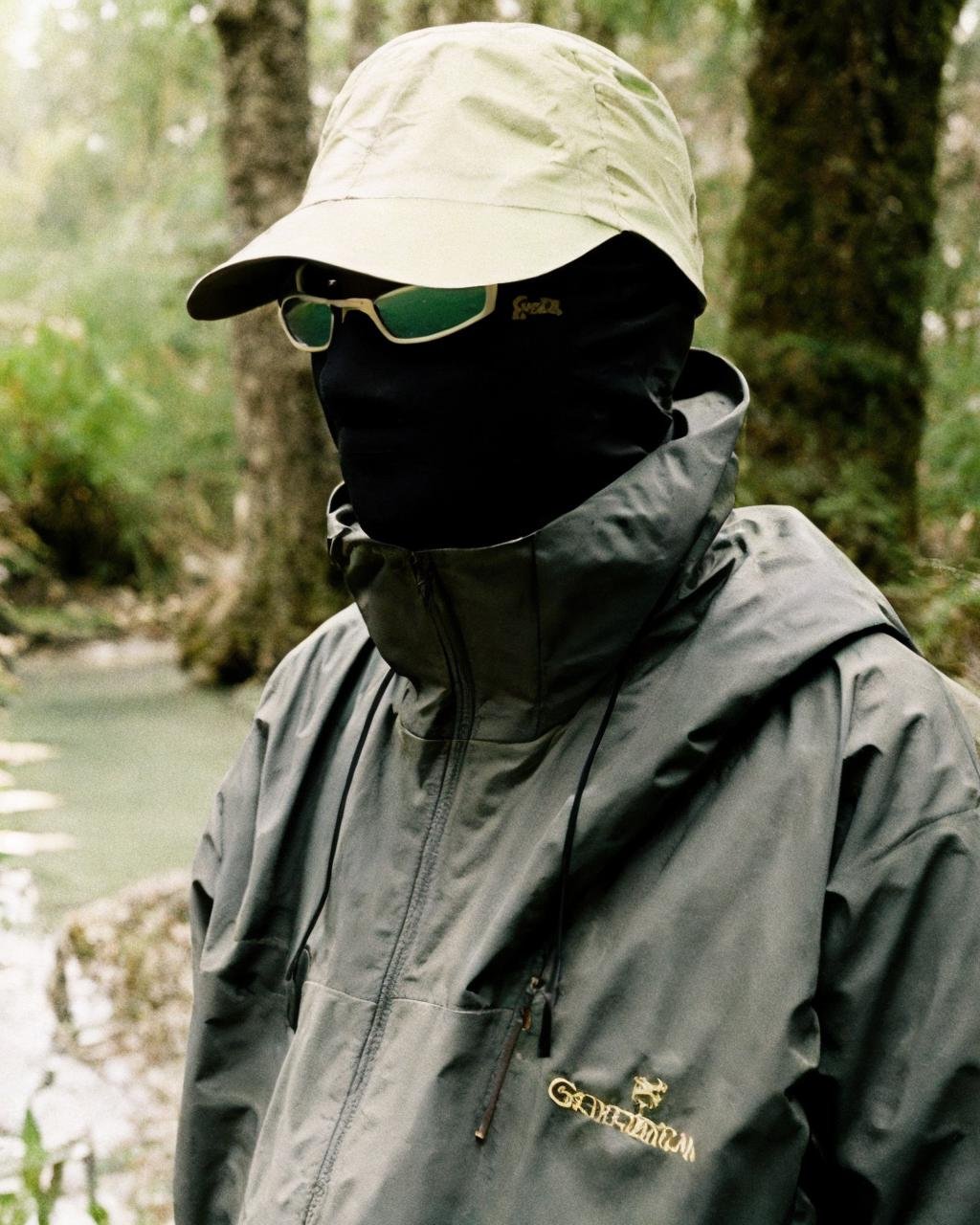 ,swamp,jungle,,black jacket,sunglasses, detailed face, masterpiece,gorpcore,80mm f/11 on kodak ektachrome e100, soft focus, film grain, muted colors,psychedelic,  <lora:gorpcoreLORA:1> 