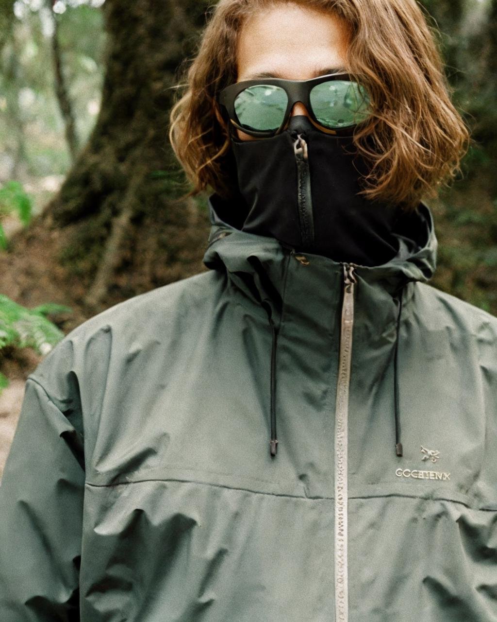 ,black jacket,sunglasses, detailed face, masterpiece,gorpcore,80mm f/11 on kodak ektachrome e100, soft focus, film grain, muted colors,swamp,jungle,,psychedelic,  <lora:gorpcoreLORA:1> 