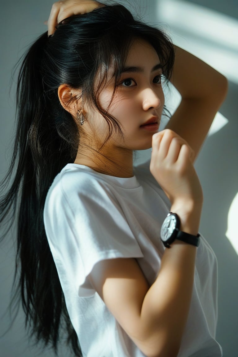 Photography, a girl with long black hair and brown eyes is captured in a dynamic pose, focusing on her upper body. She is wearing a white t-shirt with short sleeves, with her hair partially covering one eye. Her arms are raised as she looks to the side, adjusting her hair into a ponytail. A hair tie is held in her mouth, and a wristwatch is visible on her arm. A shadow falls behind her as she concentrates on tying her hair