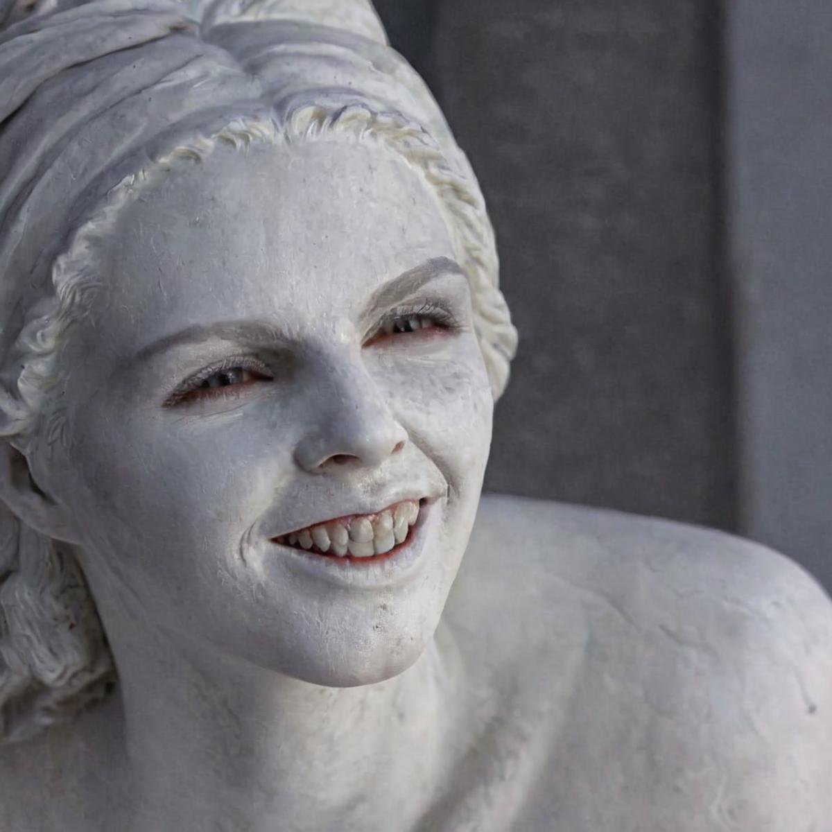 UHD, 4k, ultra detailed, cinematic, a photograph of  <lora:perfection style:0.3> <lora:sculpture v2:0.9>Marble sculpture statue of a <lora:Bram Stoker Dracula style:1> Cold White Pale Skin Gypsy Vampiress a woman with a big smile on her face, epic, beautiful lighting, inpsiring