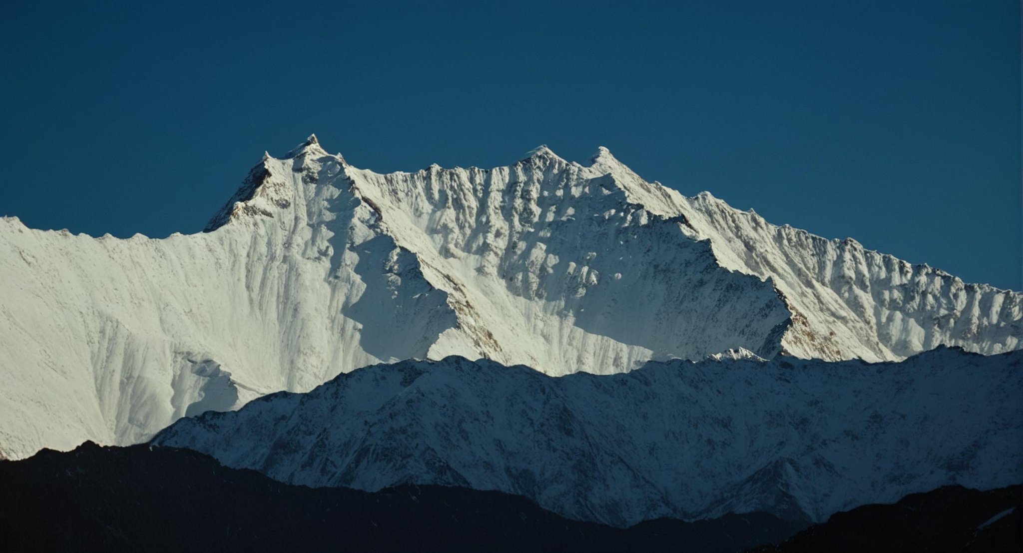 cinematic film still of  <lora:Ron Fricke style:1>a mountain range with a snow covered mountain in the background,outdoors,sky,day,blue sky,no humans,scenery,snow,mountain,landscape,mountainous horizon , realistic, realism, movie still, film grain, kodak film, film contrast, film color, cinematography, documentary, photography, 70 mm film, 65 mm film, Todd-AO, Todd-AO 35, 8K resolution, Ron Fricke film director style, Ron Fricke film directing style, Ron Fricke style, shallow depth of field, vignette, highly detailed, high budget, bokeh, cinemascope, moody, epic, gorgeous, film grain, grainy