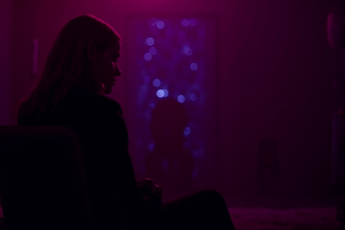 cinematic, A young woman with blonde hair sits in a dimly lit room, illuminated by soft purple and pink lighting. She gazes thoughtfully into the distance, with a bokeh of lights in the background, creating an intimate and contemplative atmosphere., film grain, Short telephoto focal length, shot on ALEXA 65