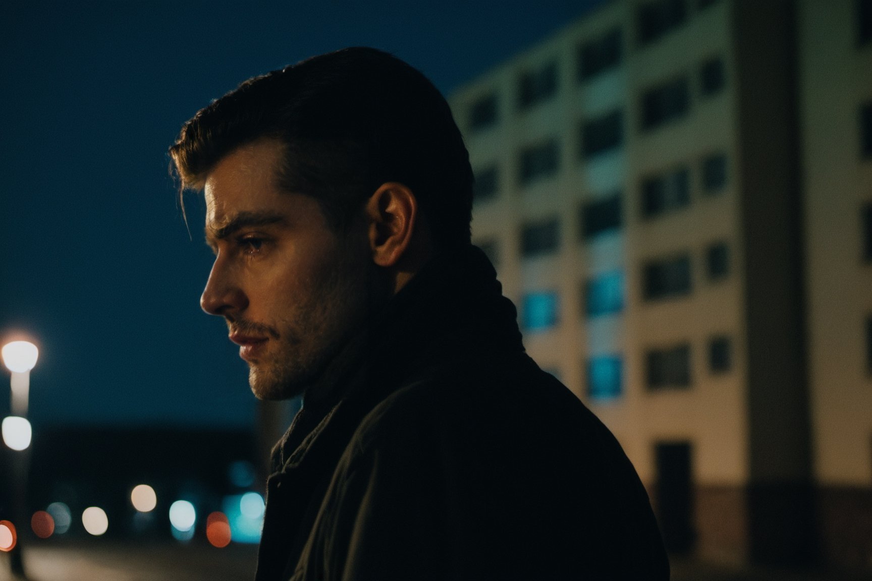 Cinematic, Photograph of a sad handsome young man close-up walks at night along a city street past squalid five-story panel houses, photorealism, cinematic,photo r3al,male,Movie Still