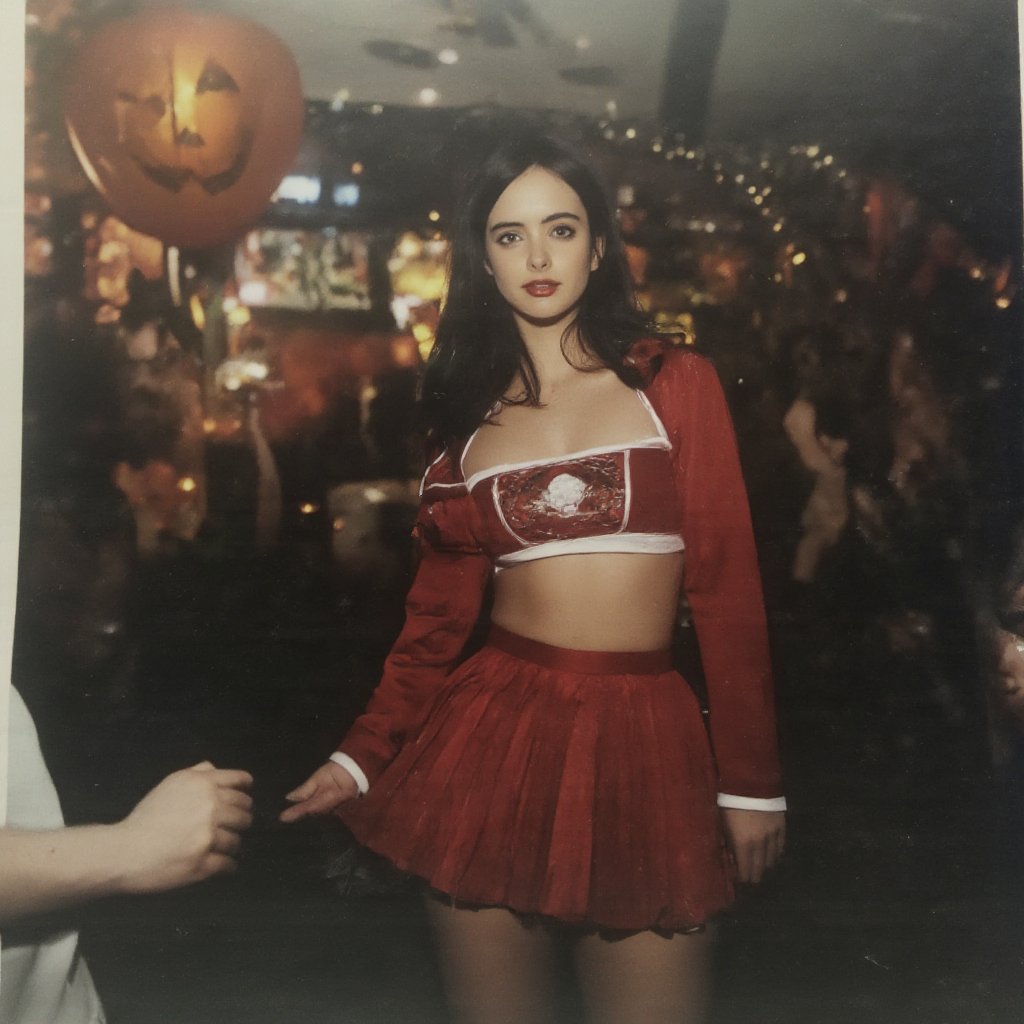 Amateur full-body snapshot of a petite college student in a red cheerleader costume at a Halloween party. 90s flair. From a 90s photoalbum. The image has a spontaneous feel. Her cleavage is clearly visible. Disco lights. Camera flash, Ideal proportions,,MeganFoxFlux,BillieEilishFlux