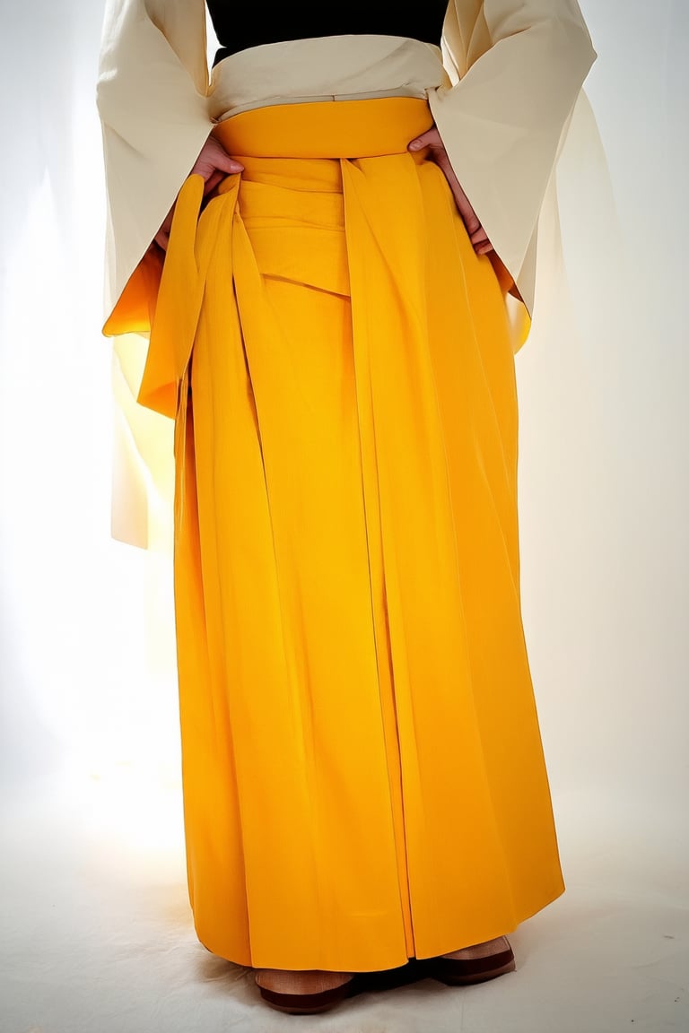 A bright yellow Hakama, traditional Japanese garment, stands out against a soft white background. The hakama's intricate design and folds are highlighted by warm natural light, casting a gentle glow on the fabric. The model, dressed in the vibrant attire, poses confidently with hands clasped behind their back, exuding a sense of cultural pride.