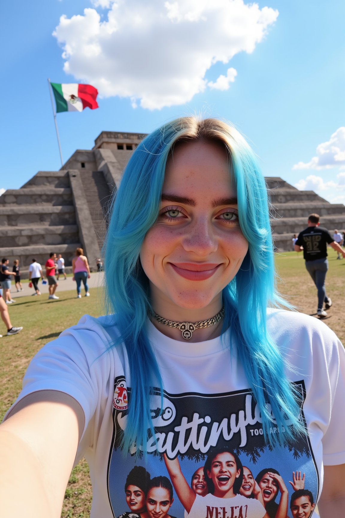 Billie Eilish taking a selfie in front of Teotihuacan. Blue hair. Wearing a shirt with Cantinflas on it. Mexican flag at background.