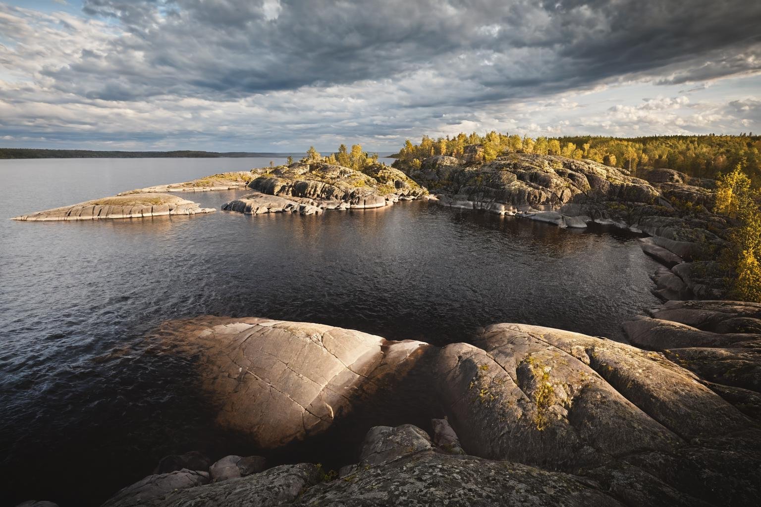 CINEMATIC SHOT, professional photo by Caravaggio of  wild nature, lake ladoga, cliffs, rocks, dramatic clouds, summer, rule of thirds,  (by Christopher Nolan:1.4),F11,(DOF, Cinematic Color grading, intricate, hyper realistic, detailed, flickr, cinematic lighting)    <lora:Wild_nature_XL:1>