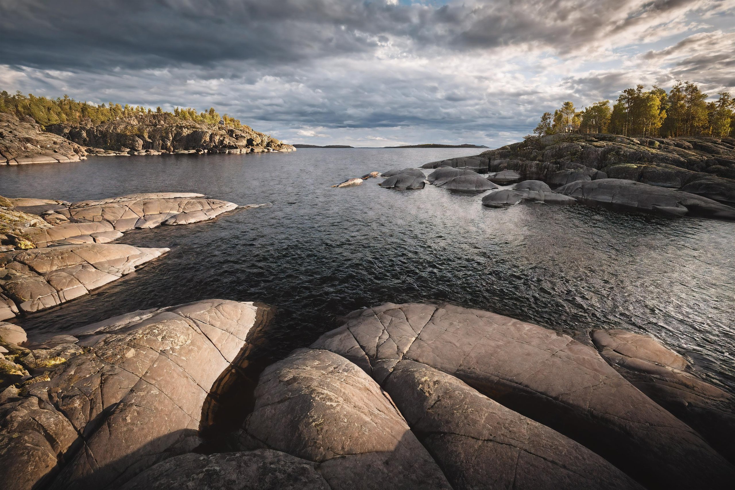 CINEMATIC SHOT, professional photo by Caravaggio of  wild nature, lake ladoga, cliffs, rocks, dramatic clouds, summer, rule of thirds, view from surface,  (by Christopher Nolan:1.4),F11,(DOF, Cinematic Color grading, intricate, hyper realistic, detailed, flickr, cinematic lighting)    <lora:Wild_nature_XL:1>