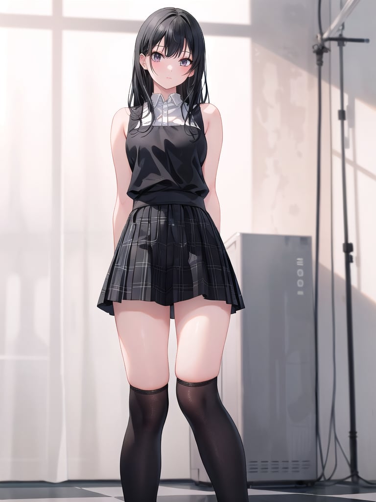 A solo female figure stands indoors, her long black hair cascading down to the floor, with bangs framing her forehead. She wears a sleeveless shirt and plaid skirt that falls just above her knees. Black thigh-high socks cover her legs, extending above knee level. Her arm is behind her back, while her feet are partially out of frame. The overall aesthetic is realistic, capturing the model's natural beauty in a subtle, understated pose.