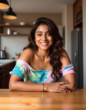 A vibrant and playful Indian girl, xshriya, sits confidently at a modern kitchen table, surrounded by the warmth of a cozy apartment. Her long, brown hair cascades down her back, swept to one side, framing her striking features. A bright smile spreads across her face, showcasing her radiant teeth. She wears an oversized tie-dye t-shirt dress that's bottomless and daringly off-the-shoulder, highlighting her curves and a delicate necklace. A bracelet adorns her wrist as she gazes directly at the camera, exuding carefree charm. The bright Instagram LUT enhances the overall aesthetic, adding a pop of color to the scene.