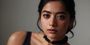 Take a photo of a woman with medium hair, wearing a tank top and a stylish collar or choker accessory, showcasing her freckles and a small, intriguing tattoo on her arm. The woman should have a slight smirk on her face, and her detailed face, especially her detailed nose, should be the focal point of the image. Use the rule of thirds composition to frame her face beautifully, and enhance the photo with dramatic lighting to add depth and intensity. Place the woman against an intricate background that complements her personality and adds to the overall story of the photograph.",lalisamanoban,rashmika 