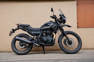 RAW photo, photo of adventure bike named Royal Enfield Himalayan, Black bike, ((no_humans))