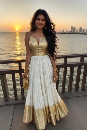 South Asian woman with long, flowing black hair and vibrant green eyes, wearing a flowing white sundress with gold bangles, smiles confidently as she holds her hand on her hip, elbow slightly bent, with a dramatic sunset casting a warm glow on her face.