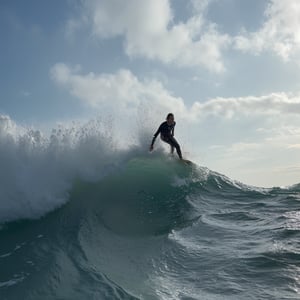 a surfer riding a large ocean wave, detailed water, crashing waves, dramatic sky, sun glare, splashing water, ocean mist, wet suit, dynamic pose, extreme action, (best quality,4k,8k,highres,masterpiece:1.2),ultra-detailed,(realistic,photorealistic,photo-realistic:1.37),dramatic lighting,cinematic composition,vibrant colors,epic scale