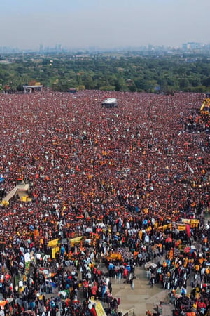 birds eye view of a very large stone temple, hundreds of people in crowd,