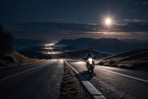 Silhouette of two motorcyclists riding down long straight road into the  cold, misty moonlit night. Low plateaued hills in background.