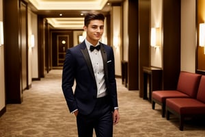 Handsome young man wearing stylish clothes, standing in a luxurious hotel lobby.