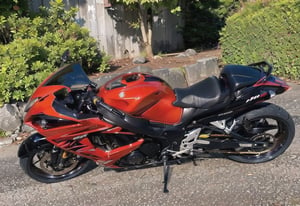there is a red motorcycle parked in a parking lot, samurai vinyl wrap, front side full, y2k”, motorcycle, profile shot, , 