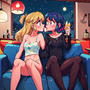 two drunk girls kissing on a sofa at midnight