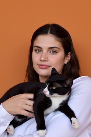 A photograph featuring wos4r4s4m holding a black cat. She has long, dark hair and is wearing a white top. She is looking directly at the camera with a slight smile. The cat is black with white striped coat. She is holding the cat in her left arm, and the cat is resting comfortably on her chest. The background is a solid, warm color, providing a contrast to the subject in the foreground