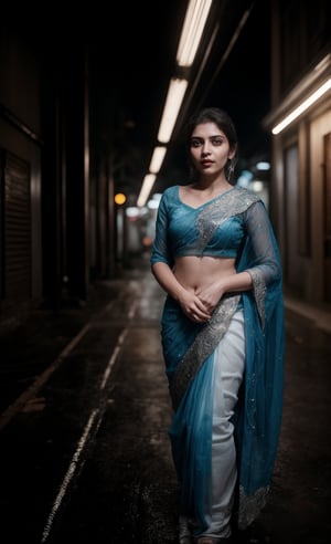 Mid shot, In a dark alleyway, neon tubes casting a futuristic glow on wet pavement, a stunning 28-year-old woman stands confidently, half of her body clad in a head-to-hip transparent saree that glistens under Tron-like lights. Electric blue and fiery orange hues dance across her features as she poses, the saree's intricate patterns reflecting off her toned skin like a digital canvas.