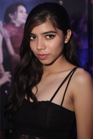  A young woman stands confidently against a movie poster backdrop, her gaze directed straight at the camera, exuding an air of confidence and allure, She wears a black top with a lace pattern, her features softly highlighted by even lighting, Off-center placement draws the viewer's eye towards her, while a subtle hint of a man in the background adds depth to the scene, The movie poster suggests a possible movie theater setting, 