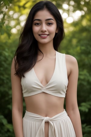 Hourglass figure, thin waist, A 35mm frame captures Kalyani Priyadarsh's radiant smile as she stands outdoors, surrounded by lush green bushes and a brick building's rustic charm. Her soft, wavy brown hair caresses her cheeks. The natural light illuminates her porcelain complexion, accentuating her elegant features. Her eyes sparkle with warmth, drawing the viewer in. Notice the gentle curve of her lips and the subtle definition of her eyebrows. A hint of transparency reveals a glimpse of her navel, adding an air of mystique to her allure. The camera's lens is unobstructed, allowing for a crisp, realistic rendering, inviting the viewer to step into this captivating scene.