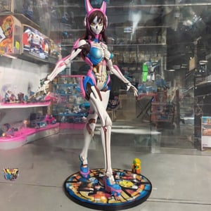 D.Va girl figure from the videogame "Overwatch", The same colours as the original character's suit, sexy figure, D.Va suit, big tits, huge breasts, big boobs, X-ray, skeleton visible, front-side pose, plastic toy, Doll limb joints, toy shop background, intricate details, realistic photograph, ActionFigureQuiron style,premium playset toy box,action figure box, diorama, in a gift box, gift box, playset,