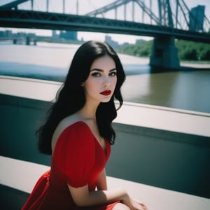 from above/high angle documentary photography analog style shot A young woman in a red sundress with long black hair and bright make-up, red lips, on a summer day in Montreal Quebec Canada, on  Jacque-Cartier Bridge in 3078. f1.4