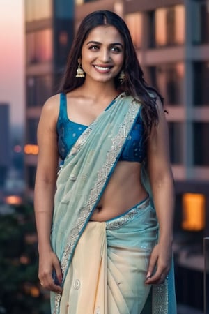 A sultry Indian woman poses confidently on a city street at dusk, surrounded by sleek skyscrapers and neon lights that cast a vibrant glow. Her traditional saree is draped in a sensual manner, showcasing her toned physique as she strikes a sassy pose. The camera captures every detail with stunning photorealism, the soft yet dramatic lighting accentuating her expressive face with smooth medium-tone skin. Her pearly white teeth gleam as she flashes a dazzling smile, her well-defined eyebrows framing large, dark eyes with luscious lashes that seem to gleam with mischief. Her long, straight brown hair cascades down her back like a waterfall of night, the cityscape providing a striking backdrop for this stunning beauty.