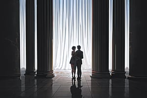 couple standing next to each other. view from behind, silhouette