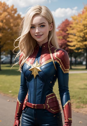 cptmarvel,blonde hair,blue eyes, bodysuit, red gloves, belt, looking at viewer, smiling, 
standing, arms crossed, outside, park, field, autumn, overcast,  extreme detail, masterpiece, lora:cptmarvel-nvwls-v1:.8, cptMarvel