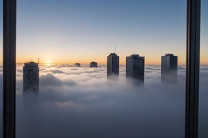 very wide shot,distant screen,eye-level,many buildings under fogs outside window,buttom-up,perspective