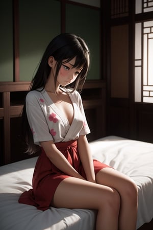 An oriental girl sits on the bed with a sad and sad expression