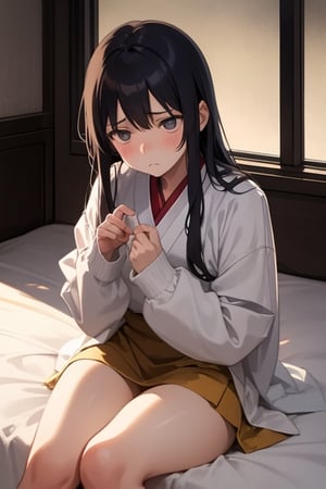 An oriental girl sits on the bed with a sad and sad expression