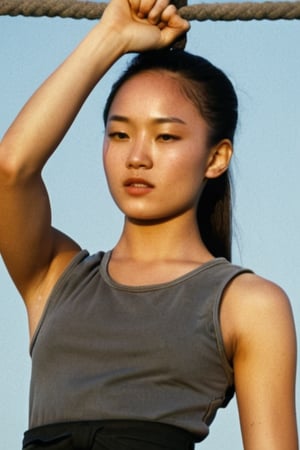 1980s Close up halfbody torso view of an outdoor skinny but skinny young mongolian   female prisoner wearing dark grey sleeveless prisoner dress. She is tied down to the restraint chair in prison, with her arms tied very high to the ceiling. She is in a situation where she is strapped down to a prison chair with her arms raised by a rope. She is also wearing very loose, flappy, dark gray prison shorts. capsleeves are very wide, leaving her armpit skin fold fully visible and exposed. Cap sleeves are designed to cover the shoulder but not extend fully over the arm, often ending just past the shoulder. In this case, the woman's cap-sleeve prison dress is short enough that her armpits are visible. This could be due to the design of the dress, or it could be a result of the pose she's striking. backlit She is very sweaty, the outside sunny weather is unbaerably hot, woman is sweating, extreme torso sweating, armpit sweating, extremly bright sunshine,She is very sweaty, the outside sunny weather is unbaerably hot, woman is sweating, extreme torso sweating, armpit sweating, extremly bright sunshine realistic armpit anatomy, errorless photo, realistic skin, realistic armpit crease lines, realistic nice toned arms, noticeable pectoral wall creating that hollowness in the armpits,Movie Still