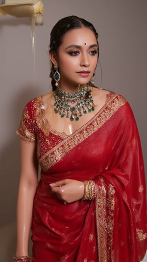 (Highest quality, Ultra HD, 16k, Masterpiece, wet clothes, wet hair, wet skin,slimy clothes, slimy hair, slimy skin:1.4), A soaking wet woman wearing a wet traditional red saree adorned with intricate gold embroidery stands elegantly. She also wears a wet red shawl with patterned design on her right side. She has a stylish wet bun decorated with small white flowers and wears stunning jewelry, including large earrings and a layered necklace featuring blue stones. Her makeup highlights her features, with a delicate bindi on her wet forehead. She poses gracefully, with one hand resting on her waist, showcasing ornate bangles. The background is softly blurred, enhancing the overall focus on her attire and beauty.. Her hair, clothes and skin are comlpletely wet. her wet clothes cling to her body. suds flowing through the body.,Fetishwet,Wet,covered in oil,covered in mud,wam,pouring oil,wetlook,pouring oil