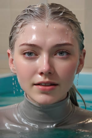 Hunter Schafer, emerging from the water. Her head and shoulders are visible above the surface of water. She looks surprised but smiling, her grey turtleneck top wet and clinging to her, with water droplets sparkling around her. She is in the middle of an indoor pool and splashes from her emergence, fully drenched, dripping wet, wet hair, face wet, face drenched