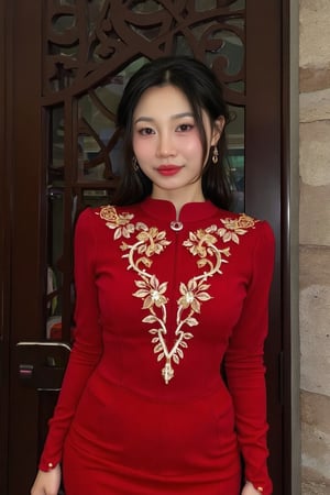 txznasian15, a young Asian woman stands in front of a dark wooden door, adorned with intricate carvings. She is dressed in a long-sleeved red dress adorned with gold embroidery and a gold ring on her finger. Her hair is pulled back, cascading over her shoulders, framing her face. Her eyes are adorned with a bold red lipstick, adding a pop of color to her lips. The backdrop is a dark brown wooden door with a intricate design. To the right of her, a brick wall is visible.