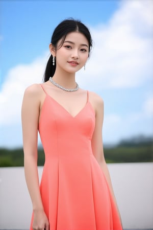 A young Asian woman stands confidently, left hand on hip, in a bold salmon-hued sleeveless dress, its radiant color amplified by a silver necklace and earrings. Her ponytailed hair adds a pop of color to her face, drawing attention to her striking features. The blurred backdrop creates a stunning contrast with the dress, while a soft blue sky with wispy clouds adds depth and serenity to the scene.,Elite beauty