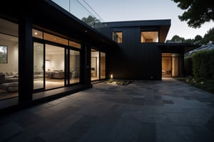 A serene photo-realistic depiction of a modern Japanese Black House, situated amidst a tranquil atmosphere. The structure's façade is a striking black, punctuated by large windows that allow natural light to filter in. A minimalist approach has been taken with the design, allowing the building's clean lines and angular shapes to take center stage. The roof, too, is black, blending seamlessly into the surrounding landscape. In the foreground, a stone-paved courtyard invites contemplation, its simple beauty enhanced by the stark contrast of the house's dark exterior.